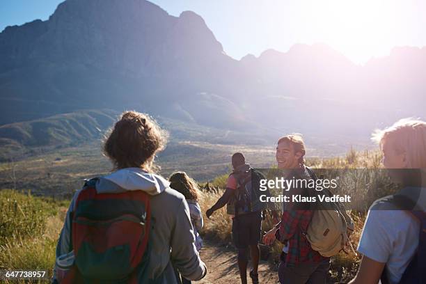 friends trekking in the mountains and laughing - activities in the sun stockfoto's en -beelden