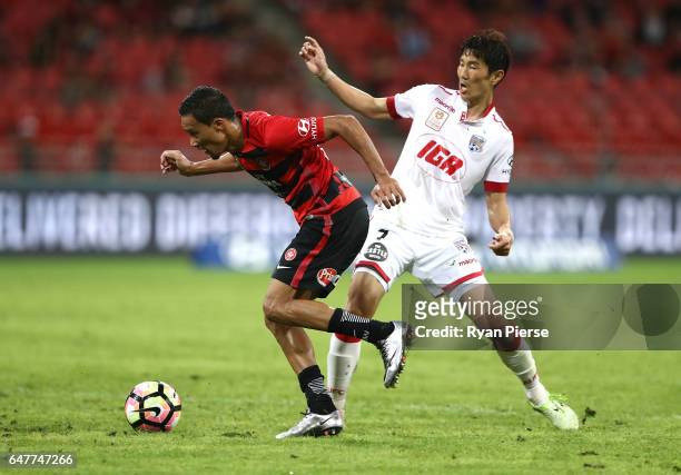 Kearyn Baccus of the Wanderers competes for the ball against Jae-Sung Kim of Adelaide United during the round 22 A-League match between the Western...