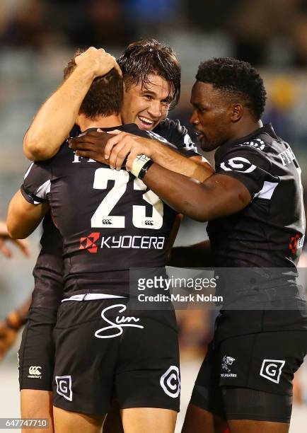 Kobus Van Wyk of the Sharks celebrates with team mates after winning the round two Super Rugby match between the Brumbies and the Sharks at GIO...