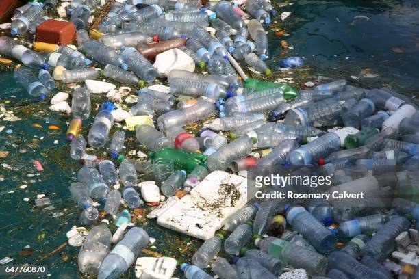 garbage floating in ocean. - water pollution stock pictures, royalty-free photos & images