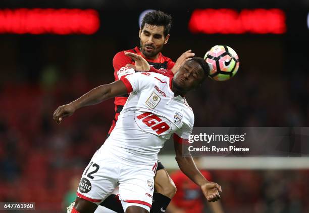 Mark Ochieng of Adelaide United competes for the ball against Dimas of the Wanderers during the round 22 A-League match between the Western Sydney...
