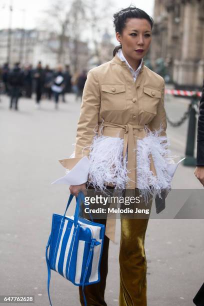 Jeannie Lee carries a Balenciaga bag outside the Issey Miyake show on March 3, 2017 in Paris, France.