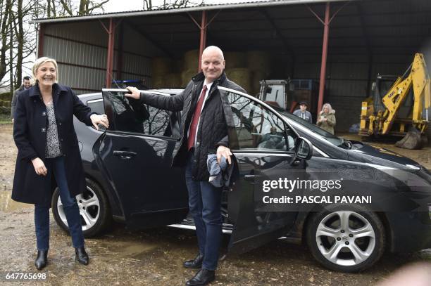 French far-right Front National party candidate for the presidential election Marine Le Pen flanked by her bodyguard Thierry Legier, arrives to visit...