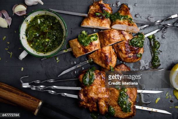 barbequed chicken breast skewers with chimichurri sauce - roast chicken table stockfoto's en -beelden