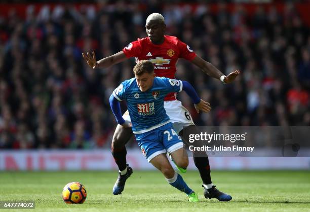 Ryan Fraser of AFC Bournemouth and Paul Pogba of Manchester United battle for possession during the Premier League match between Manchester United...