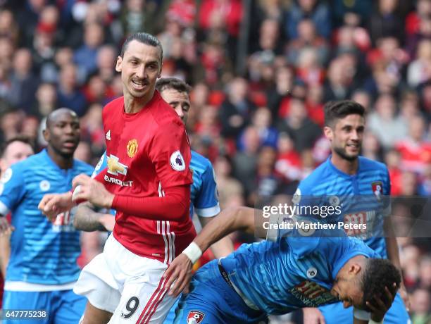 Zlatan Ibrahimovic of Manchester United clashes with Tyrone Mings of AFC Bournemouth during the Premier League match between Manchester United and...