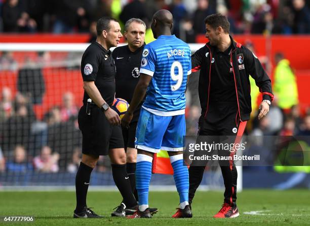 Referee Kevin Friend , Benik Afobe of AFC Bournemouth and Jason Tindall, AFC Bournemouth assistant manager argue at half time during the Premier...