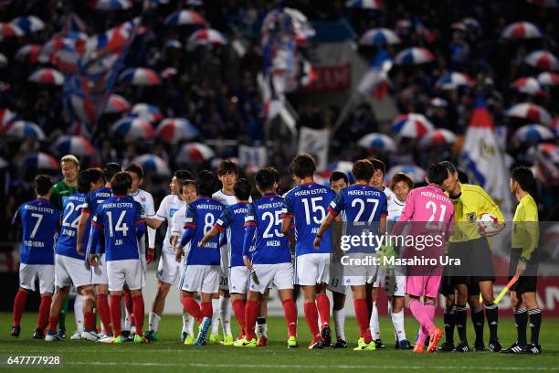 Players shake hands after the J.League J1 match between Yokohama F.Marinos and Consadole Sapporo at Nippatsu Mitsuzawa Stadium on March 4, 2017 in...