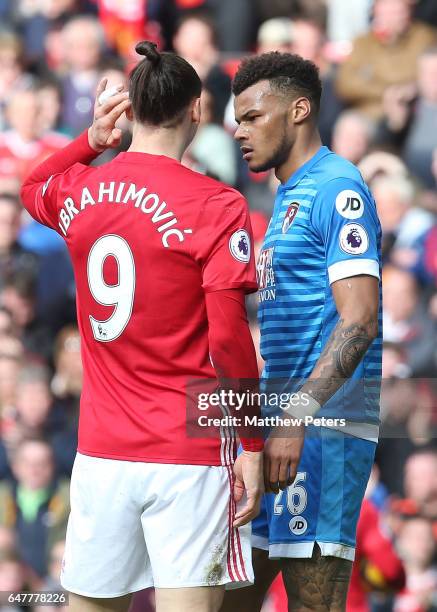 Zlatan Ibrahimovic of Manchester United clashes with Tyrone Mings of AFC Bournemouth during the Premier League match between Manchester United and...