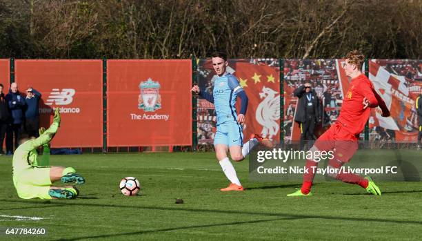 Glen McAuley of Liverpool and goalkeeper Arijanet Muric of Manchester City in action during the U18 Premier League match between Liverpool and...