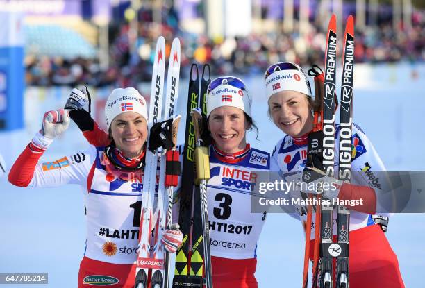 Second placed Heidi Weng of Norway, first place Marit Bjoergen of Norway and third place Astrid Uhrenholdt Jacobsen of Norway pose following the...