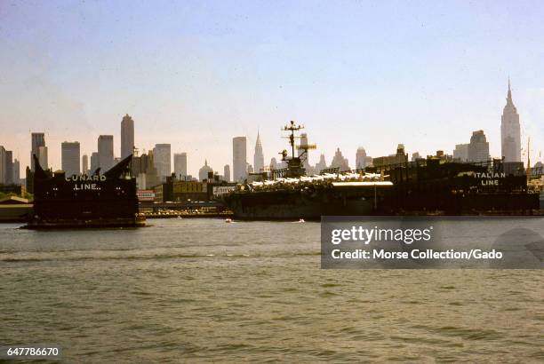View from the Hudson River of the Cunard Line and Italian Line piers at the New York City Passenger Ship Terminal, known as Luxury Liner Row, in the...