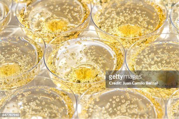 glasses with bubbling champagne at a wedding - champagne stock-fotos und bilder