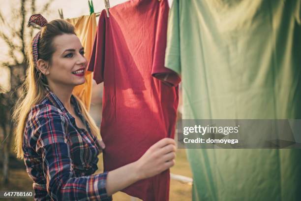 beautiful vintage girl doing laundry - clothes wringer stock pictures, royalty-free photos & images