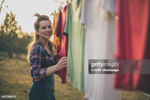 lovely pin-up girl having fun with housework - clothes wringer stock pictures, royalty-free photos & images