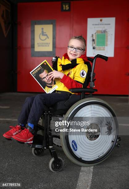 Watford fan reads the match day programme prior to the Premier League match between Watford and Southampton at Vicarage Road on March 4, 2017 in...