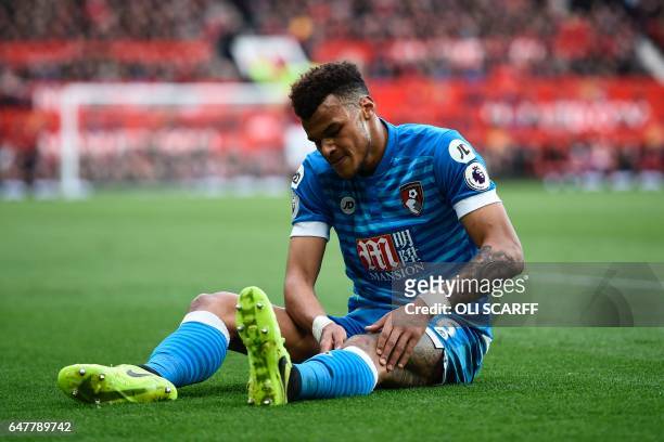 Bournemouth's English defender Tyrone Mings lies injured during the English Premier League football match between Manchester United and Bournemouth...