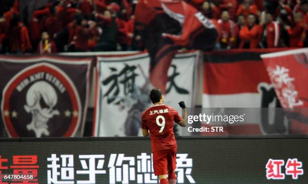 Shanghai SIPG's Brazilian forward Elkeson celebrates after scoring a goal during the Chinese Super League match against Changchun Yatai in Shanghai...