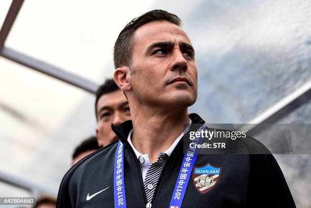 Tianjin Quanjian's head coach Fabio Cannavaro looks on before the Chinese Super League match against Guangzhou R&F in Guangzhou, south China's...