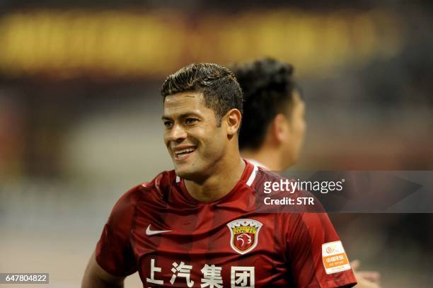 Shanghai SIPG's Brazilian forward Hulk reacts after scoring a goal during the Chinese Super League match against Changchun Yatai in Shanghai on March...