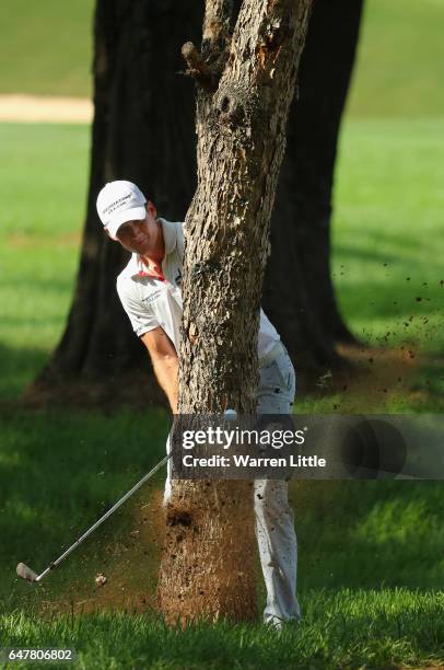 Garth Mulroy of South Africa plays his second shot on the 18th hole from behind a tree during the third round of the Tshwane Open at Pretoria Country...