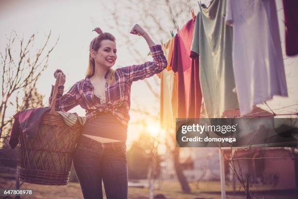 retro styled girl doing housework - clothes wringer stock pictures, royalty-free photos & images