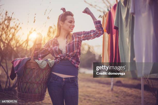 retro styled girl doing housework - clothes wringer stock pictures, royalty-free photos & images