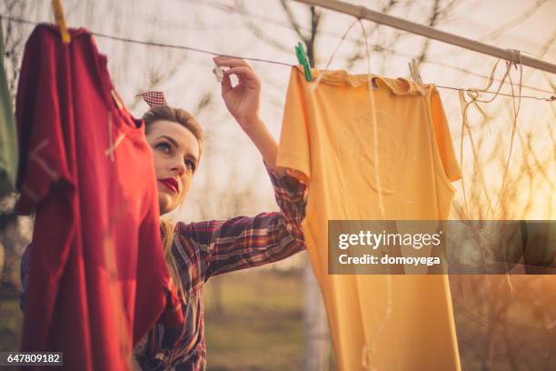 lovely girl hanging laundry - clothes wringer stock pictures, royalty-free photos & images