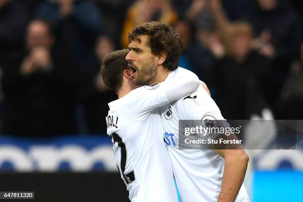 Fernando Llorente of Swansea City celebrates scoring his sides first goal with Tom Carroll of Swansea City during the Premier League match between...