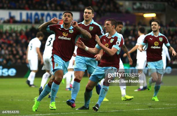 Andre Gray of Burnley celebrates scoring his sides first goal with his Burnley team mates during the Premier League match between Swansea City and...