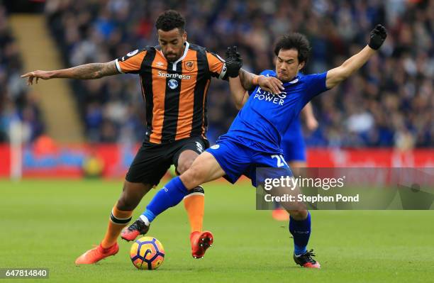 Tom Huddlestone of Hull City and Shinji Okazaki of Leicester City battle for possession during the Premier League match between Leicester City and...
