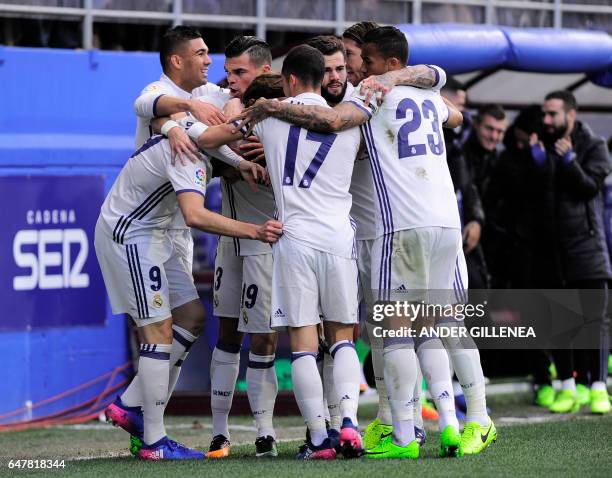 Real Madrid's players celebrate after French forward Karim Benzema scored their team's first goal during the Spanish league football match SD Eibar...