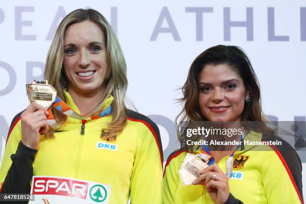 Gold medalist Cindy Roleder of Germany and bronze medalist Pamela Dutkiewicz of Germany pose during the medal ceremony for the Women's 60 metres...