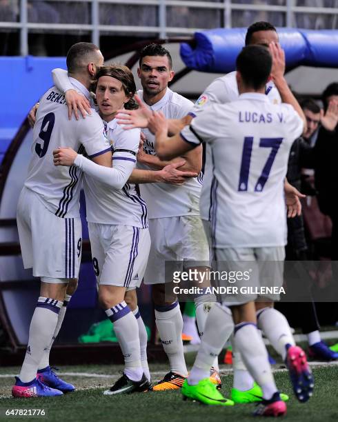 Real Madrid's French forward Karim Benzema celebrates with Real Madrid's Croatian midfielder Luka Modric and Real Madrid's Portuguese defender Pepe...
