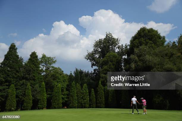 Scott Jamieson of Scotland passes his ball to his caddie on the 12th green during the third round of the Tshwane Open at Pretoria Country Club on...
