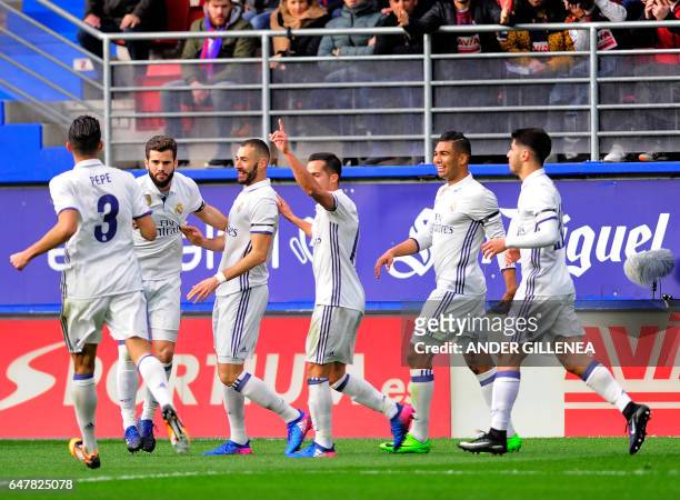 Real Madrid's French forward Karim Benzema celebrates with teammates after scoring their team's first goal during the Spanish league football match...