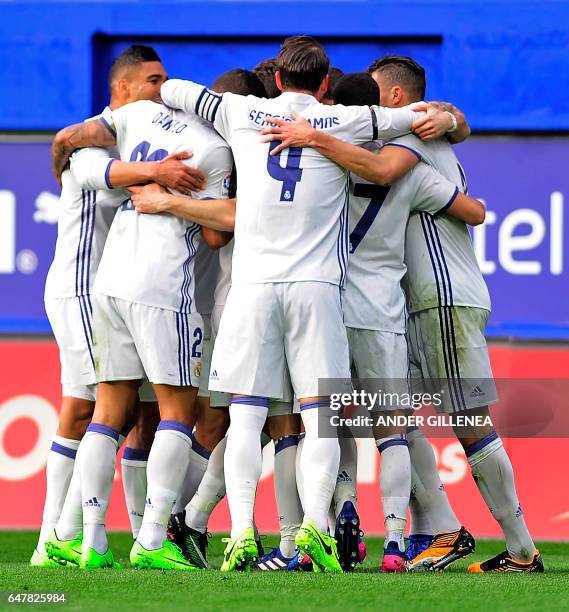 Real Madrid's players celebrate after French forward Karim Benzema scored their team's second goal during the Spanish league football match SD Eibar...