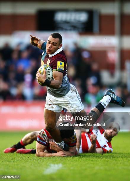 Joe Marchant of Harlequins is tackled by Jacob Rowan and Charlie Sharples of Gloucester during the Aviva Premiership match between Gloucester Rugby...