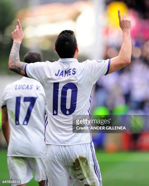 Real Madrid's Colombian midfielder James Rodriguez celebrates after scoring their team's third goal during the Spanish league football match SD Eibar...