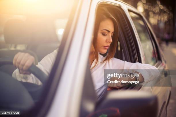 beautiful businesswomen checking the time - top priority stock pictures, royalty-free photos & images