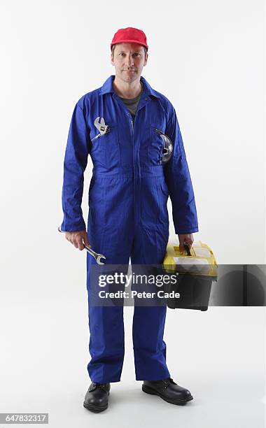 workman stood holding tools - coveralls ストックフォトと画像