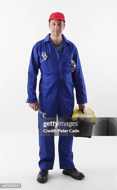 workman stood holding tools - tradesman toolkit stock pictures, royalty-free photos & images