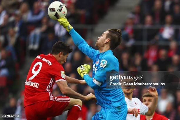 Goalkeeper, Thomas Kessler of Koeln punches the ball away from Robert Lewandowski of Bayern Munich during the Bundesliga match between 1. FC Koeln...