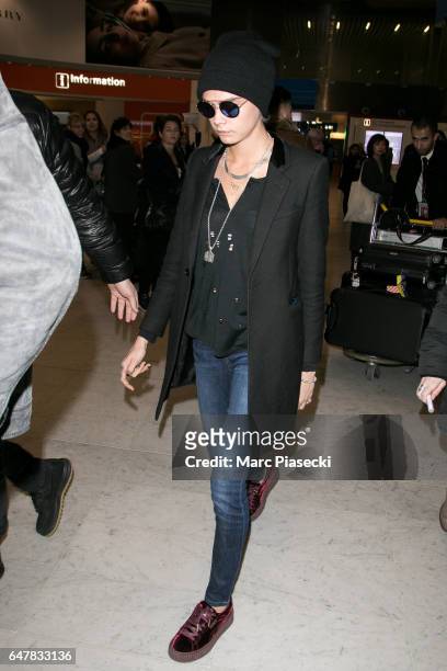 Cara Delevingne arrives at Charles-de-Gaulle airport on March 4, 2017 in Paris, France.