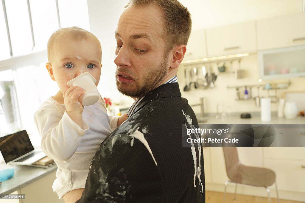 Father and baby, yogurt spilt down suit