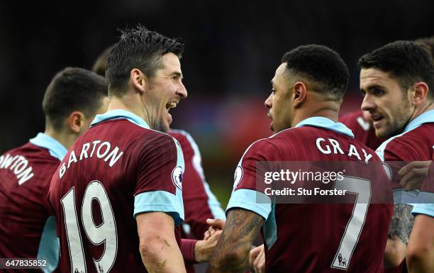 Andre Gray of Burnley celebrates scoring his sides second goal with Joey Barton of Burnley during the Premier League match between Swansea City and...