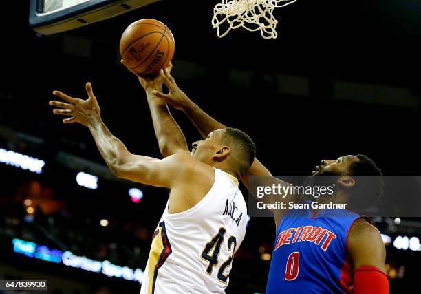 Alexis Ajinca of the New Orleans Pelicans is blocked by Andre Drummond of the Detroit Pistons during a game at the Smoothie King Center on March 1,...