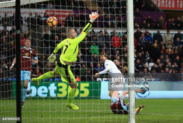 Fernando Llorente of Swansea City scores his sides third goal past Paul Robinson of Burnley during the Premier League match between Swansea City and...