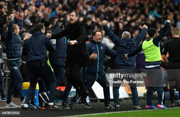Swansea manager Paul Clement celebrates the winning goal with his staff during the Premier League match between Swansea City and Burnley at Liberty...