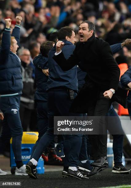 Swansea manager Paul Clement celebrates the winning goal with his staff during the Premier League match between Swansea City and Burnley at Liberty...